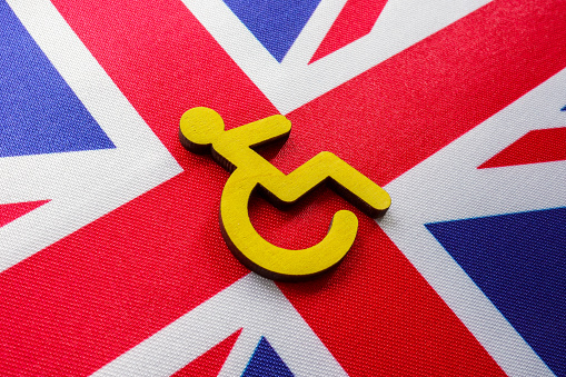 Flag of the Great Britain and disabled person sign.