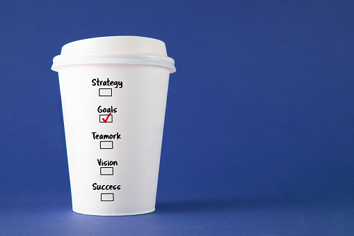 Conceptual shot with paper coffee cup with business related words as a choice on it