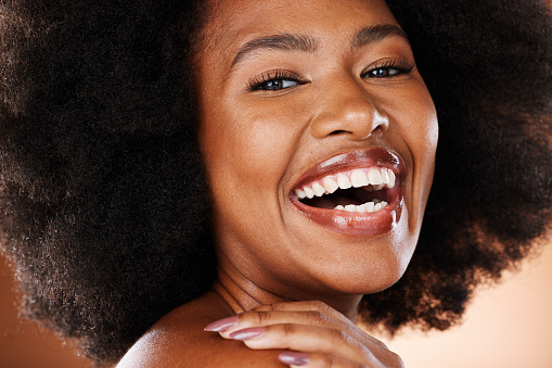 Beauty, face and black woman with makeup and natural cosmetics portrait, afro and skincare closeup against studio background. Happy model, cosmetic advertising and hair care, facial and healthy skin.