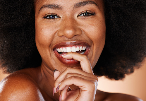 Black woman with natural smile, beauty portrait in studio and cosmetics skincare for face with healthy teeth. Happy african girl, afro hair care in Brazil and luxury makeup with mascara lashes