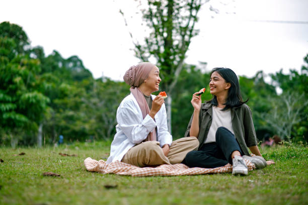 istock Happy sisters spending weekend together  at the park. 1456736932