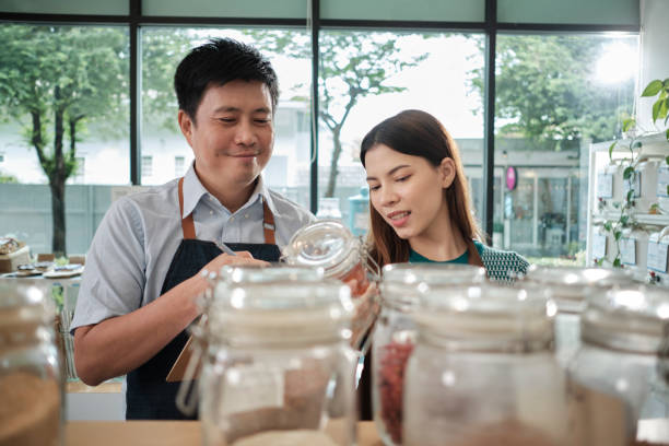 istock Two shopkeepers check stock in zero waste and plastic-free grocery store. 1456740001