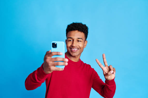 istock Cheerful black man showing victory sign 1456740099