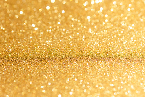 istock Golden glittering background for design and free space. 1456741701
