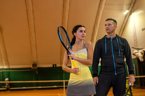 pair of tennis players a man and a woman are standing on a tennis court with rackets. sport concept. Pair sports