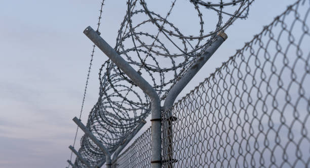 Restricted area, fence with barbed wire Fence with barbed wire, restricted area international border stock pictures, royalty-free photos & images