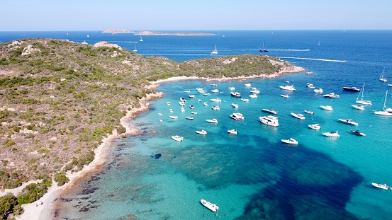 Aerial view of sailboats parked in a sea bay of Costa Smeralda, Sardinia, Italy