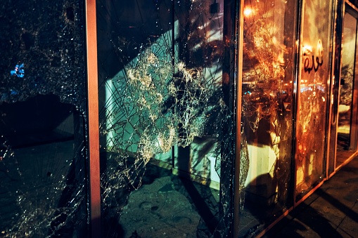 Photojournalism, broken shopfront, crime night scene, the background of a damaged showcase of shops, the consequences of revolution, Beirut, Lebanon