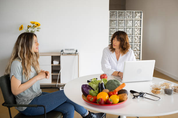 istock Nutritionist speaking with patient at table with laptop 1456753427