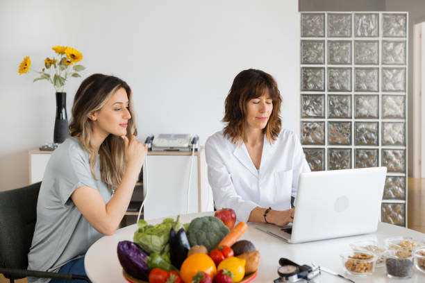 istock Nutritionist speaking with patient at table with laptop 1456753477