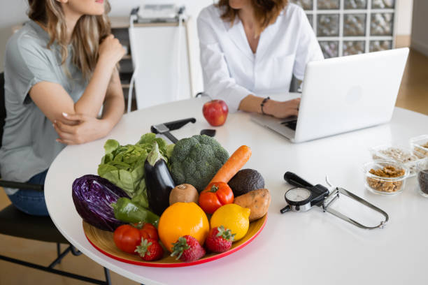 istock Cropped Nutritionist speaking with patient at table with laptop 1456753504