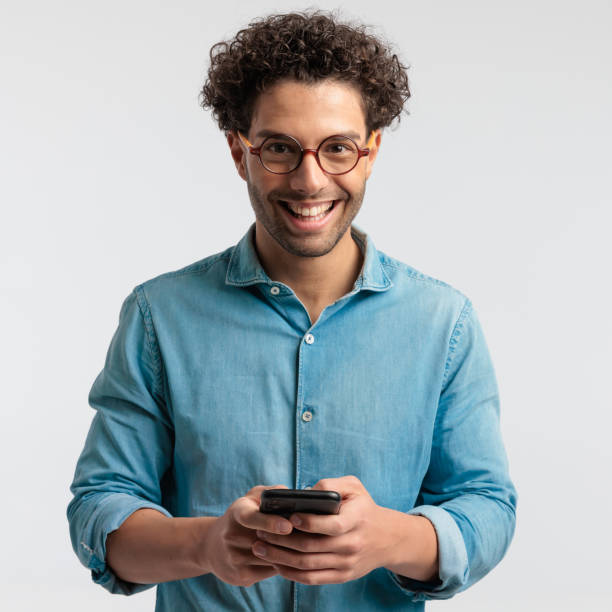 istock casual man having fun texting on his phone 1456754686