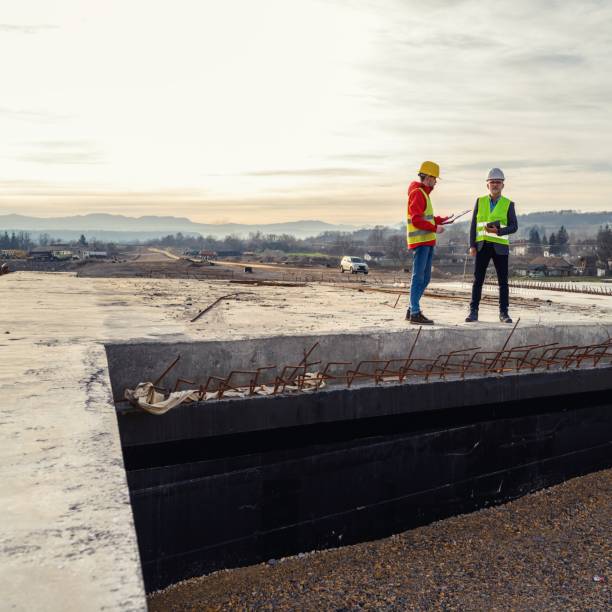 istock Engineer and investor on a road construction site 1456757511