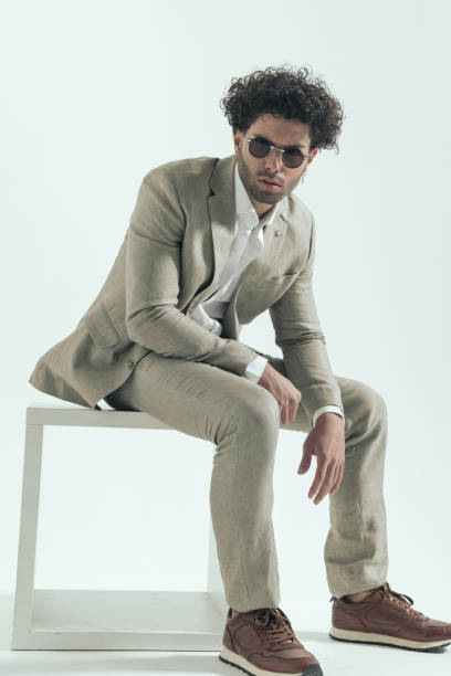 istock confident arabic man with curly hair sitting and posing in a cool way 1456757561