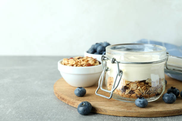 istock Concept of tasty breakfast with yogurt on gray textured table 1456757955