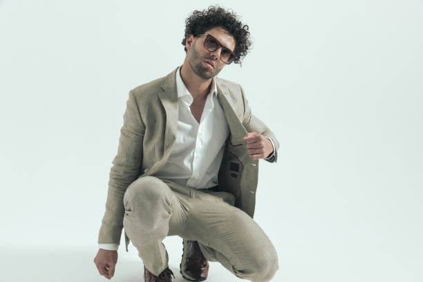 istock cool fashion arabic man with sunglasses crouching and pulling suit 1456757983