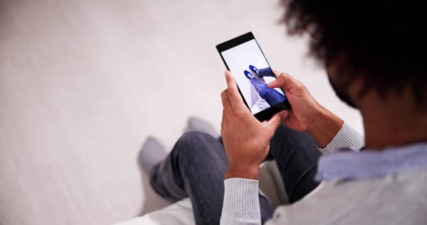 istock Man Trying Virtual Sneakers In Shop 1456759185