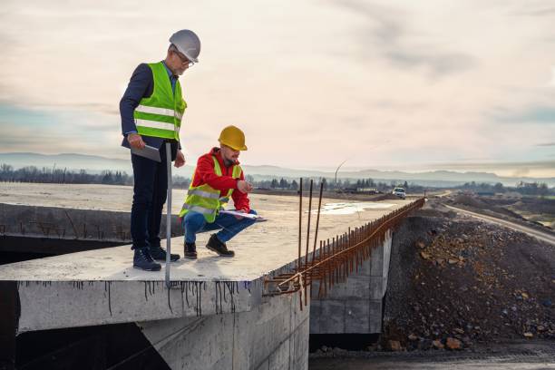 istock Engineer and investor on a road construction site 1456759963
