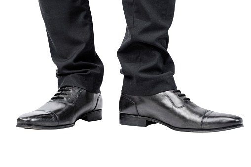 Closeup view of the businessman's foot isolated over white background