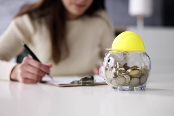 istock Piggy Bank With Safety Hard Hat 1456761186
