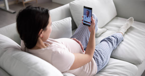 istock Pregnant Woman Using Online Video Call With Doctor 1456761322