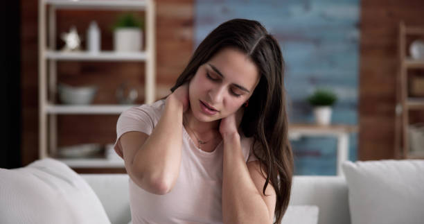 Young Woman Suffering From Neck Pain stock photo