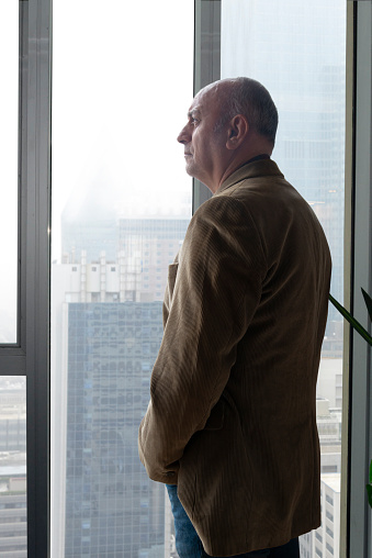 Businessman looking out the office window