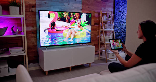 istock Woman Watching TV Through Tablet Television 1456761921
