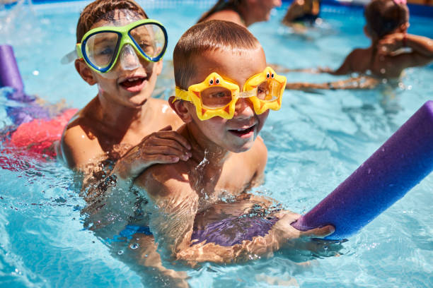 istock Children games in swimming pool 1456761976