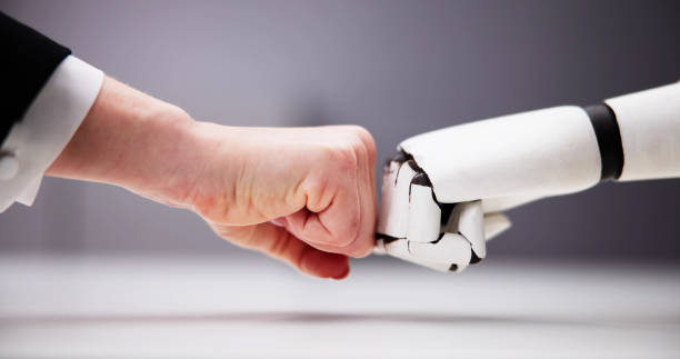 istock Robot And Human Hand Making Fist Bump 1456762313