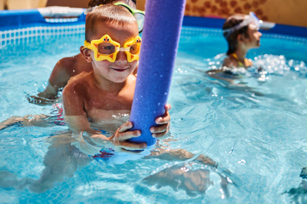 istock Children games in swimming pool 1456762357