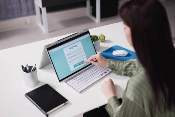 istock Businesswoman's Hand Filing Online Registration Form 1456763056