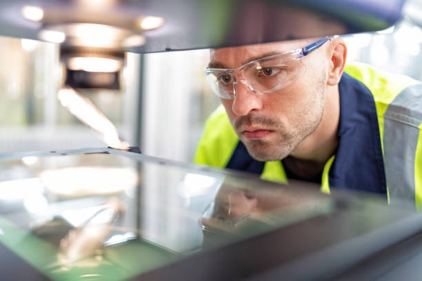 istock Engineer sitting in robot fabrication room use measuring microscope machine check electronic board 1456763088