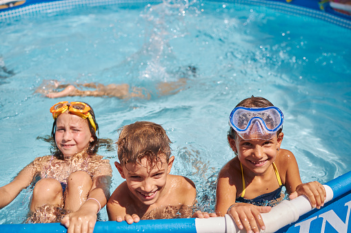 Group of friends playing in swimming pool.