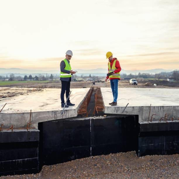 istock Engineer and investor on a road construction site 1456763530