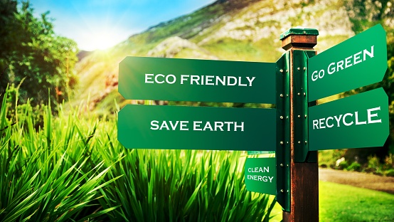 Signpost in the park with conceptual directions, eco friendly, go green, recycle and save earth, conceptual photo of ecology pollution and needs to protection nature