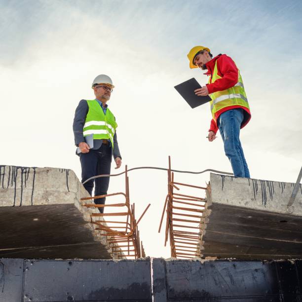 istock Engineer and investor on a road construction site 1456765436