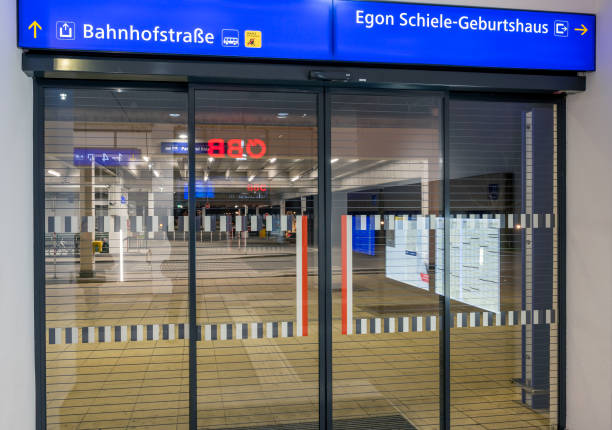 glass sliding door with blue info signs at the exit to the famous painter Egon Schiele birthplace from the trainstation of Tulln at the Danube, Austria