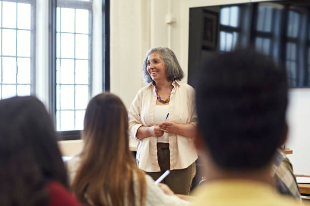 istock Cheerful woman in early 50s teaching college class 1456768680