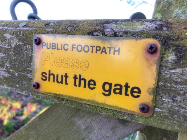istock Old public footpath sign reading please shut the gate 1456772840
