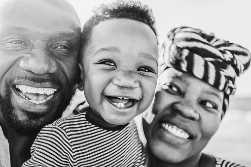 African family having fun outdoor - Main focus on baby eyes - Black and white editing