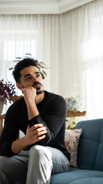 istock Handsome man looks worried at home 1456778269