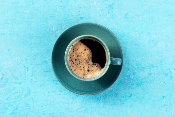 istock Coffee cup, overhead flat lay shot on a blue background, espresso drink 1456778464