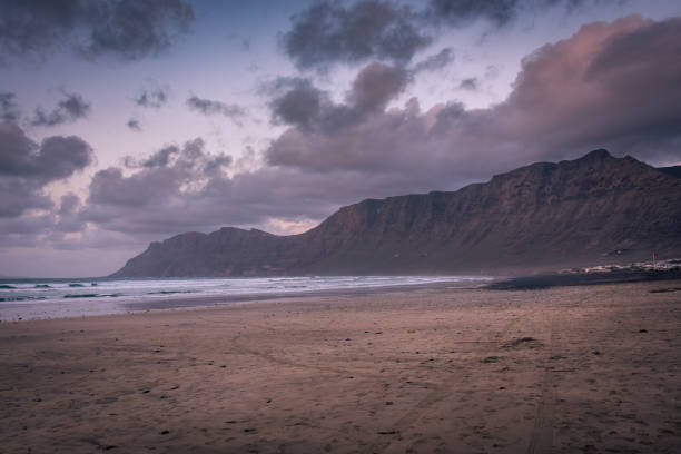 The amazing Famara beach on the Atlantic Ocean in Lanzarote, Canary Islands,  Spain The amazing Famara beach on the Atlantic Ocean in Lanzarote, Canary Islands, Spain caleta de famara lanzarote stock pictures, royalty-free photos & images