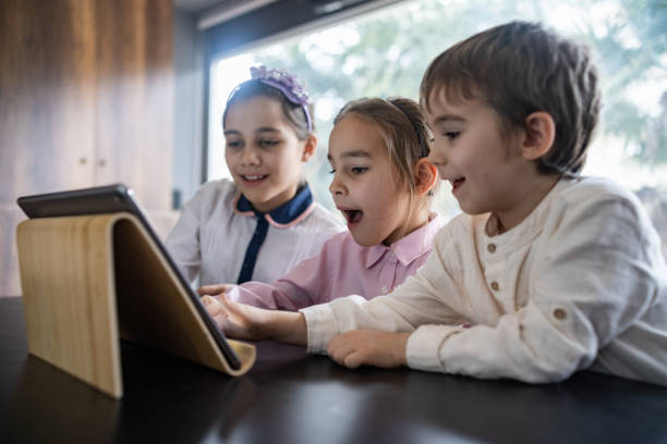 istock Children Playing Video Game Using Digital Tablet At Home 1456783955