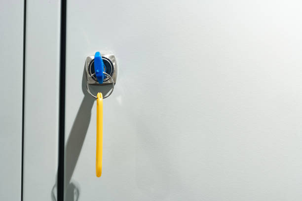 Gray locker with key for safety in public facility close up