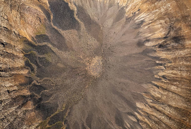 Overhead aerial view of Caldera de Montana Blanca volcanic crater near Timanfaya National Park, Lanzarote, Canary islands, Spain. stock photo