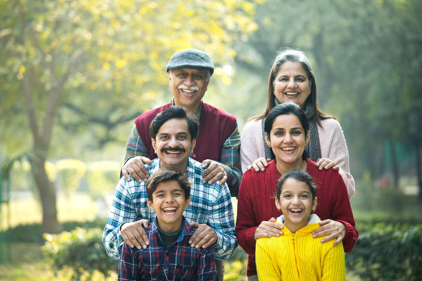 istock Cheerful multi generation family standing back to back at park 1456792697