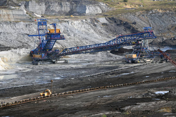 istock Bucket-wheel excavator during excavation at the surface mine. Huge excavator on open pit mine. 1456792890