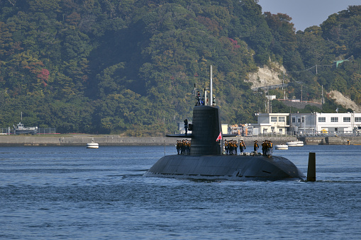 Naval modern submarine on open sea surface.